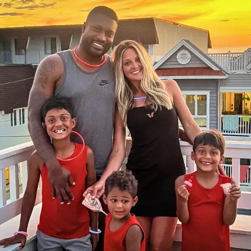 Rachelle, Dorin and the grandkids posing together outdoors at sunset.